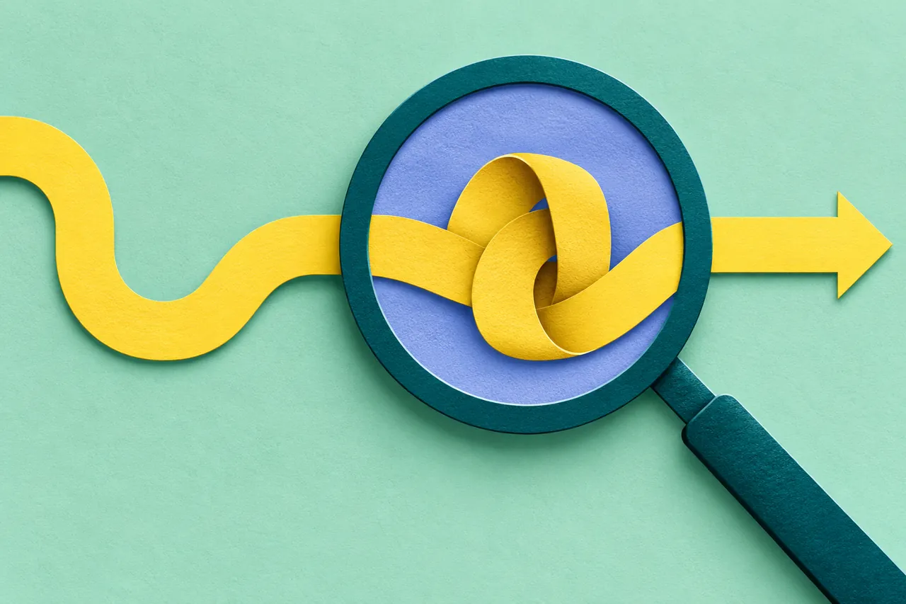 A large teal magnifying lens reveals an unexpected bend in a yellow paper path